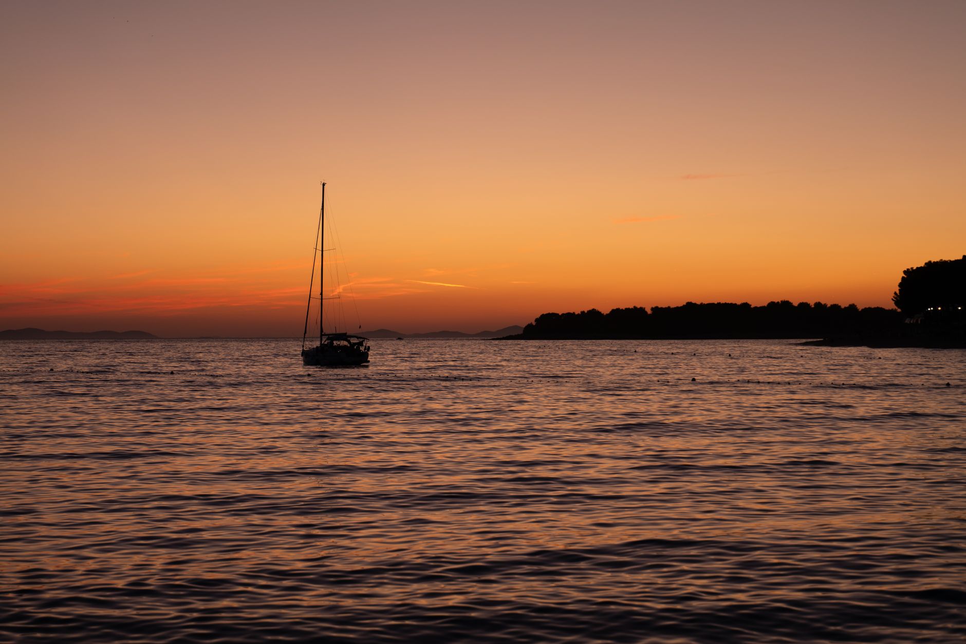 Yacht under sail at sunset